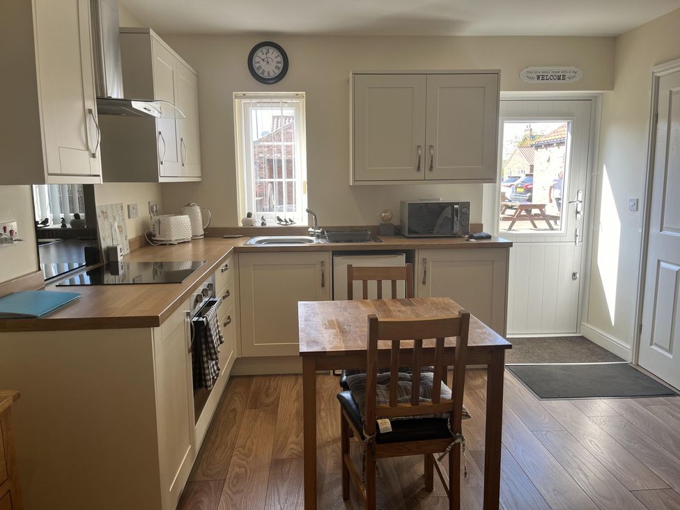 A kitchen with a table and chairs at TBC in 