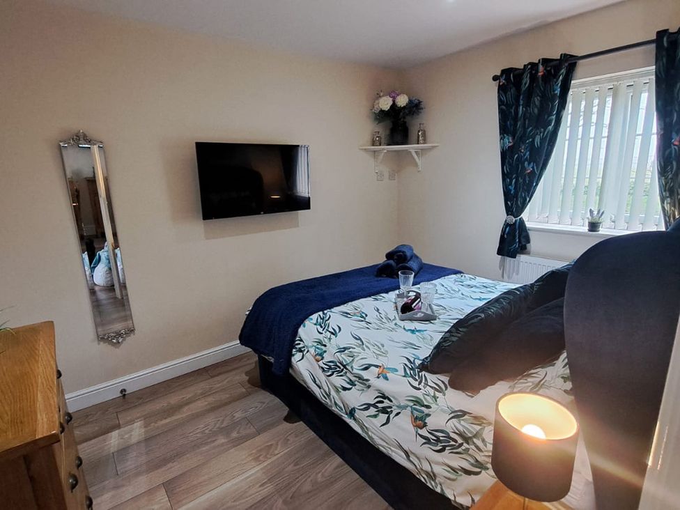 A bedroom with a bed and television at TBC in 