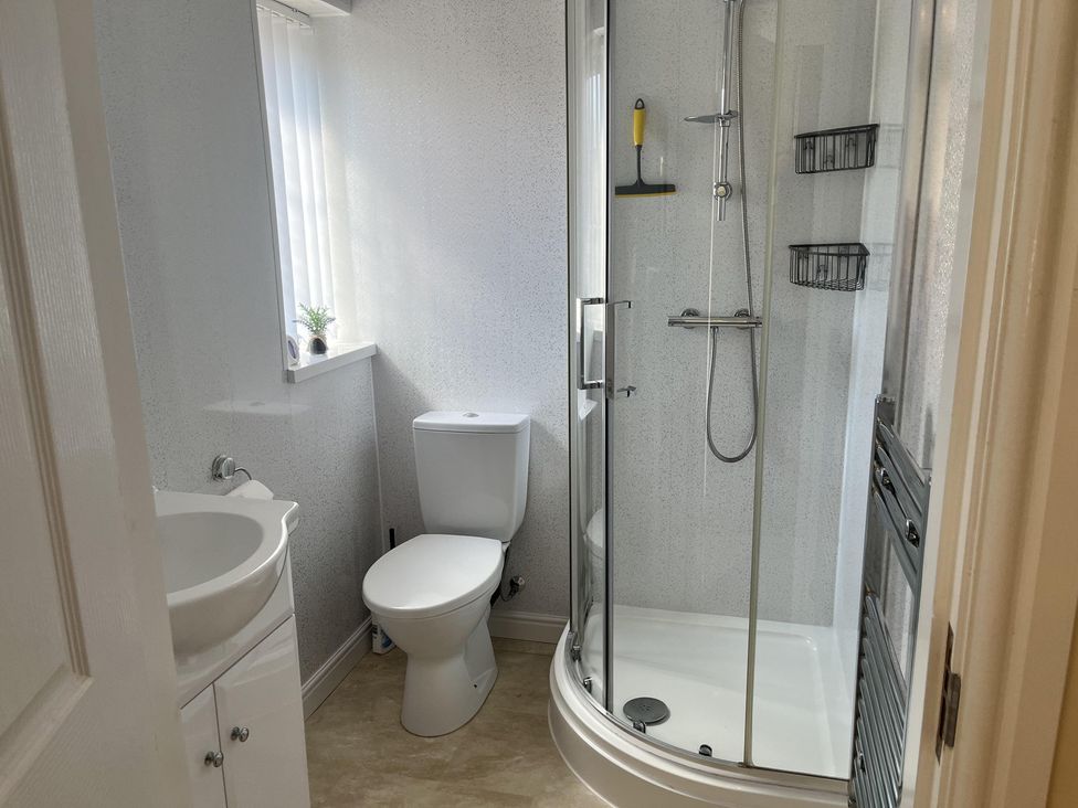 A bathroom with a shower toilet and sink at TBC in 