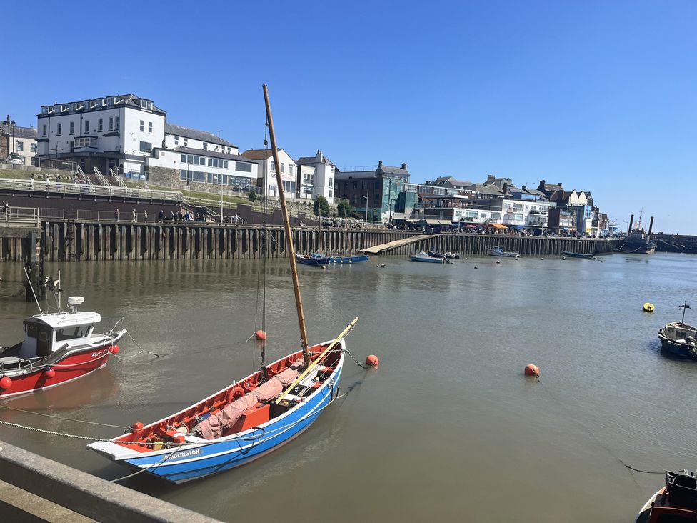 A view of boats on water with buildings and a pier at TBC 
