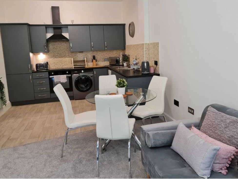 A kitchen with cabinets and appliances at TBC