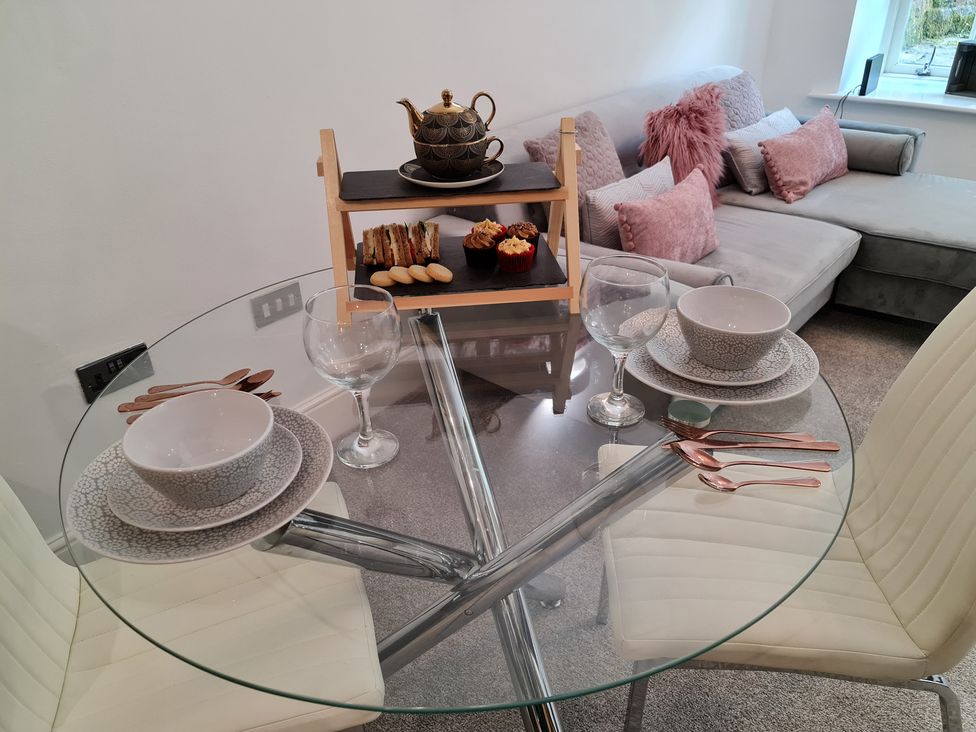 A dining table with tea set and snacks at TBC 