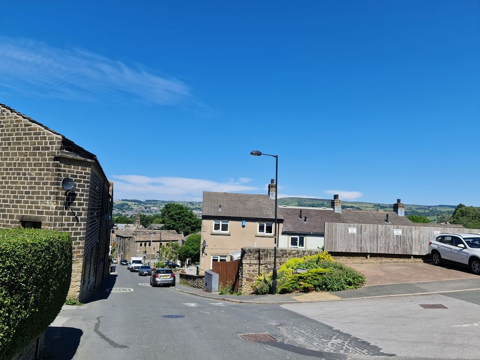 A street view with houses and cars at TBC
