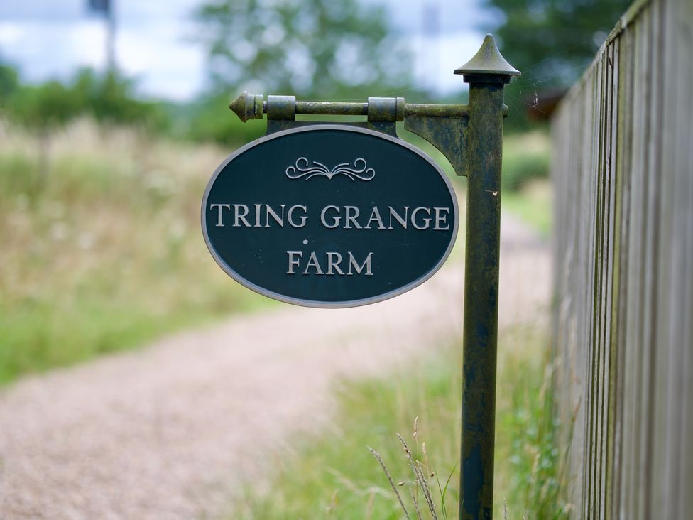 A sign that reads Tring Grange Farm in an outdoor setting at TBC