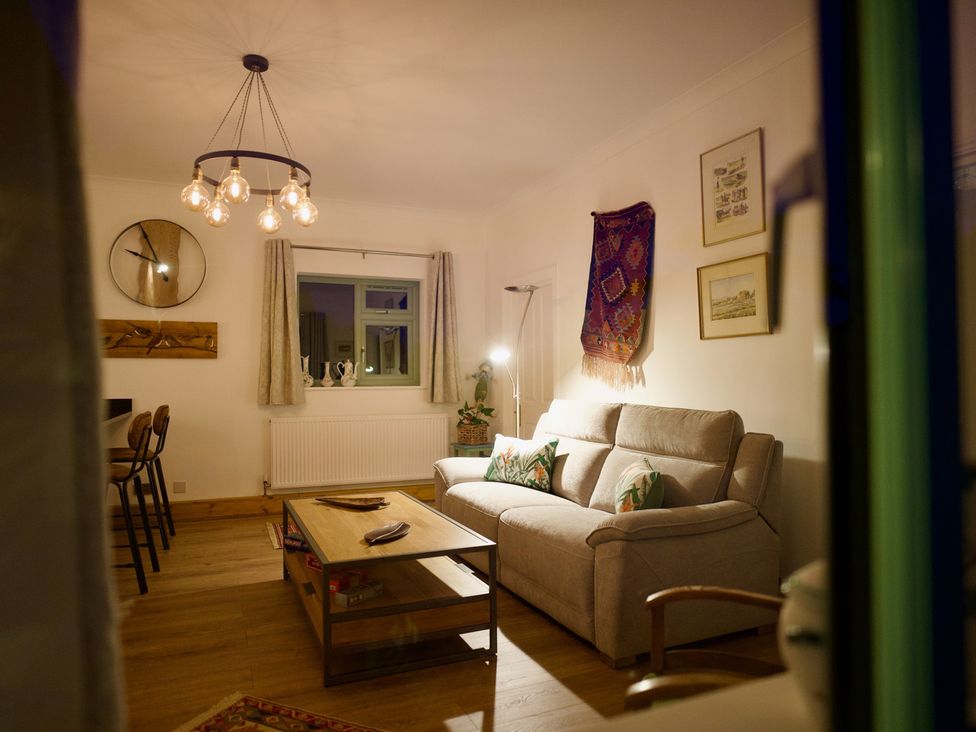 A living room with a sofa and coffee table at TBC