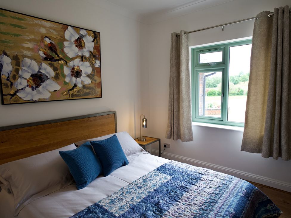 A bedroom with a bed and a window at TBC