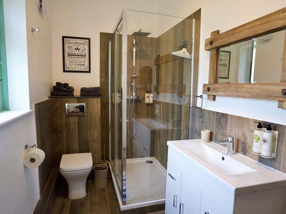A bathroom with a shower and sink at TBC 