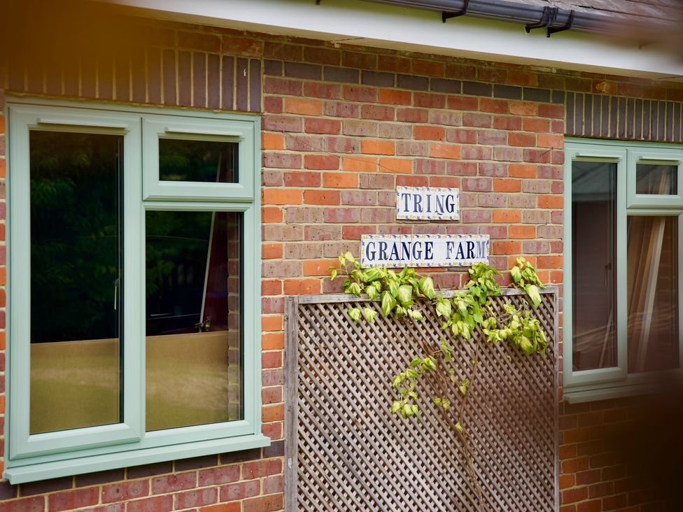 An exterior wall with windows and a nameplate at TBC