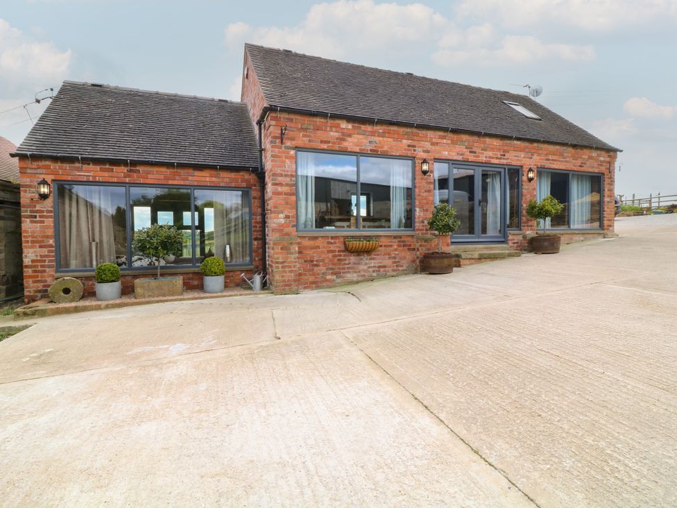 A house with windows and planters at The Croft, Home Farm in Ripley
