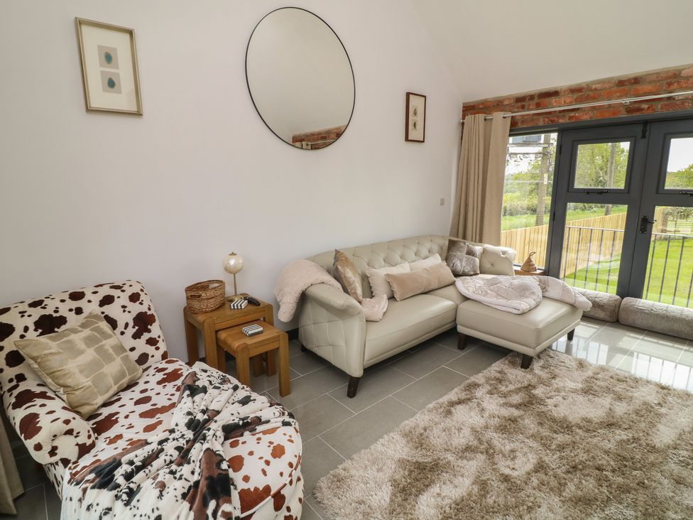 A living room featuring a sofa and armchair at The Croft, Home Farm Ripley
