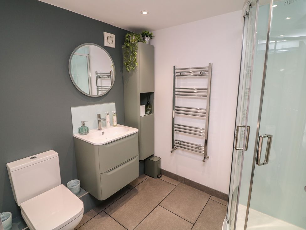 A bathroom with a shower and sink at The Croft, Home Farm Ripley