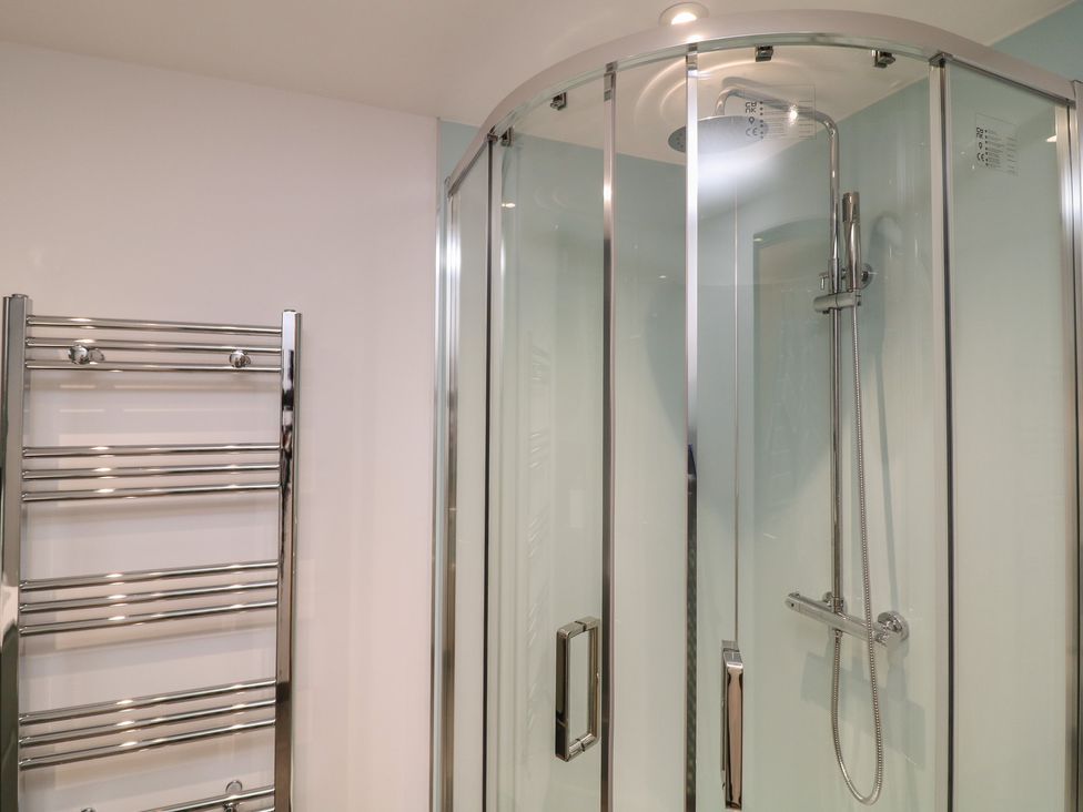 A bathroom with a shower and towel radiator at The Croft, Home Farm Ripley