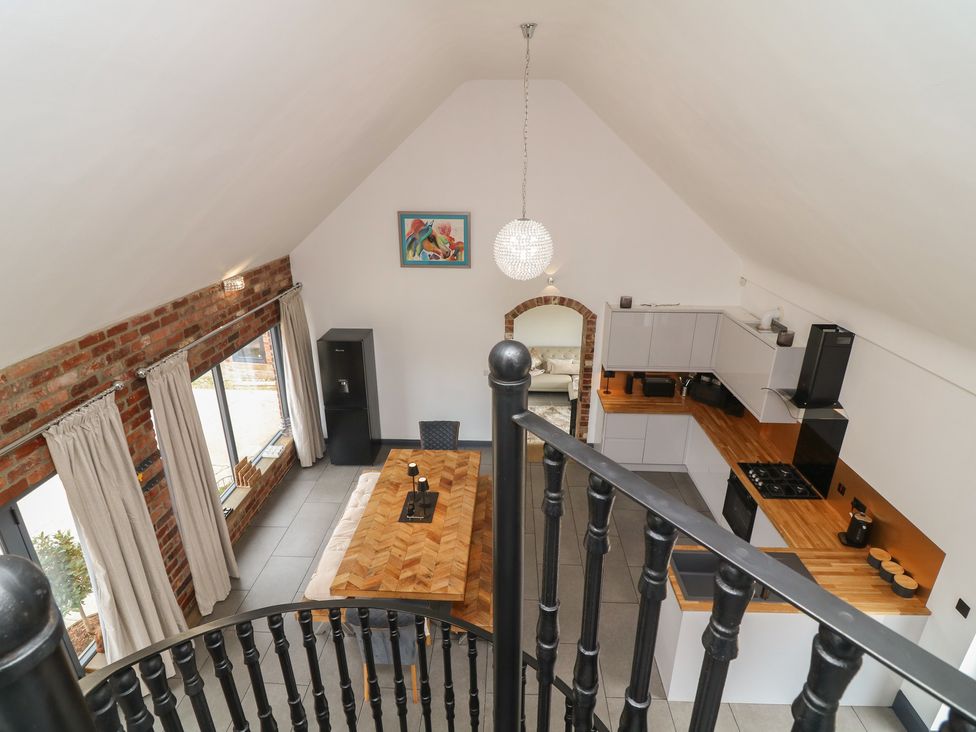 A kitchen with a dining table and chairs at The Croft, Home Farm Ripley