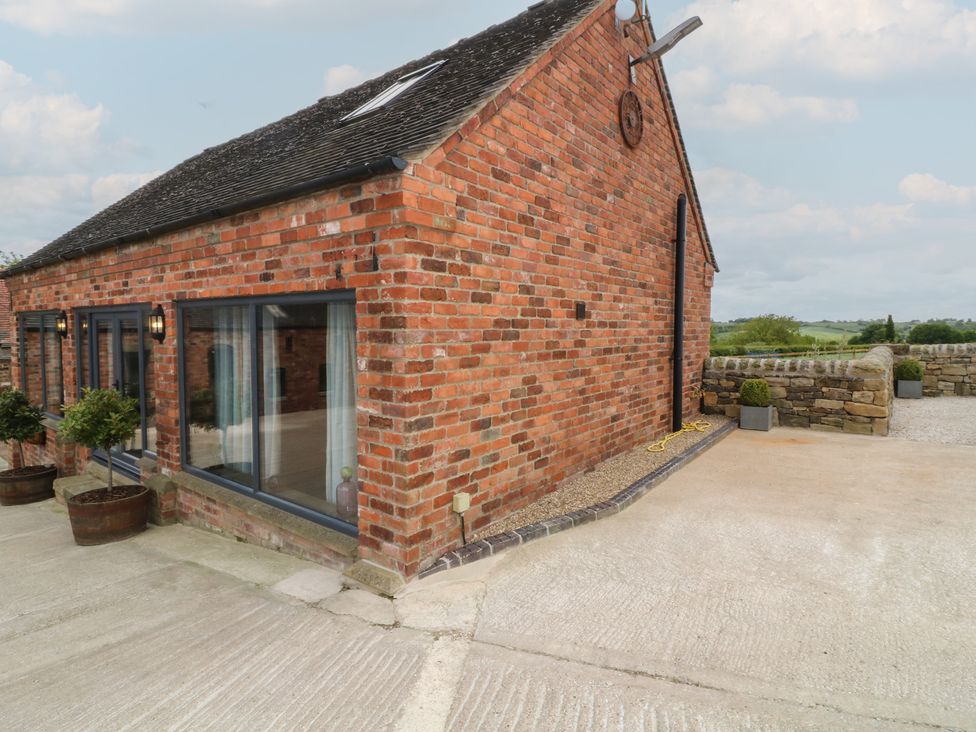 An outdoor area with brick exterior and potted plants at The Croft, Home Farm Ripley