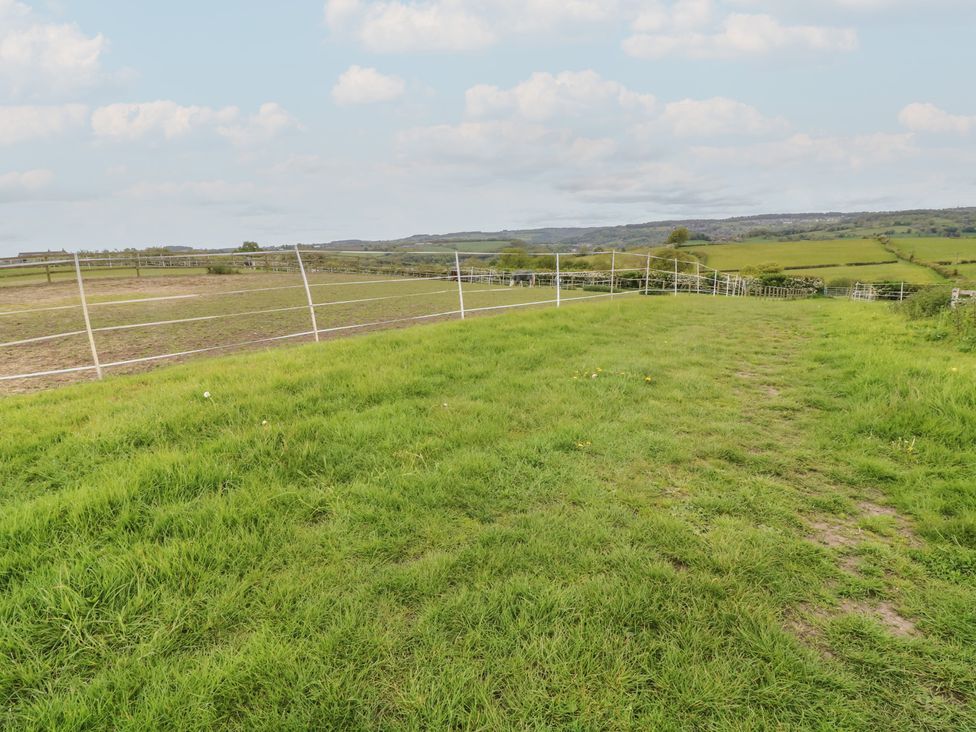 An outdoor field with grass and a fence at The Croft, Home Farm Ripley