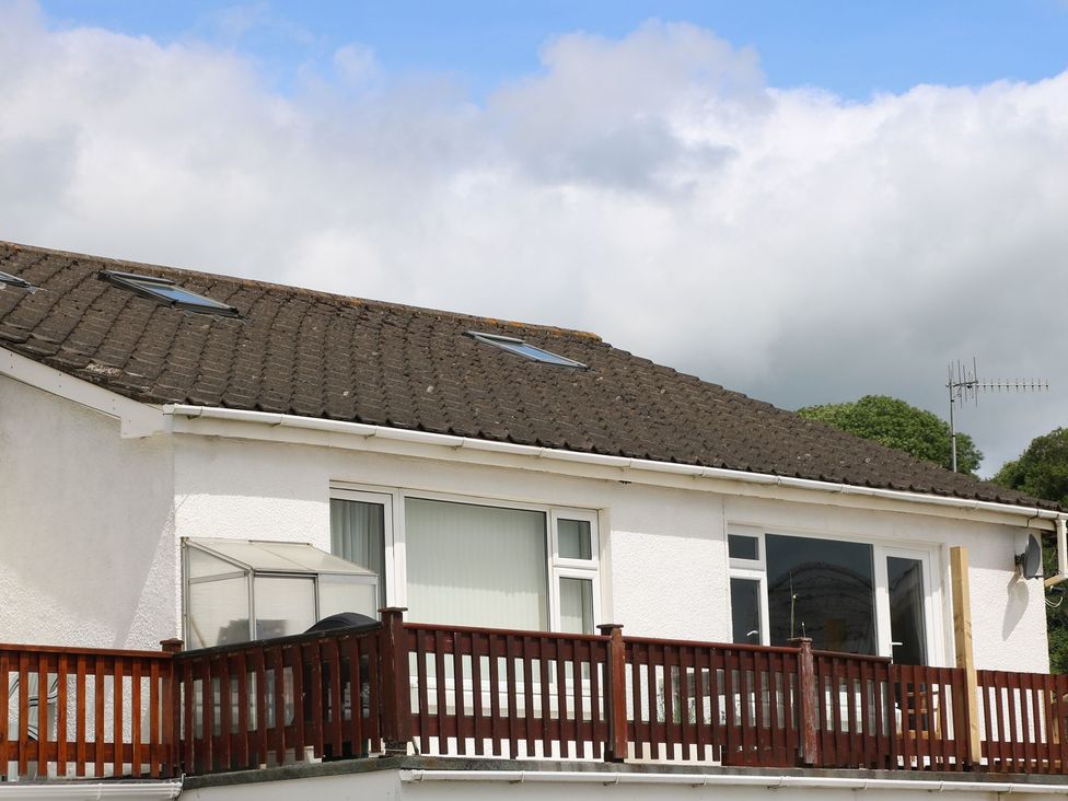 A house with a balcony and windows at The Cartwheel in Amroth