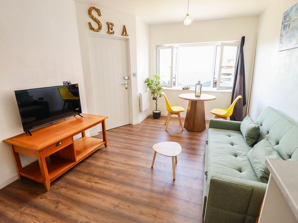 A living room with a sofa and table at The Ocean House--- Sea Shell in Hunstanton