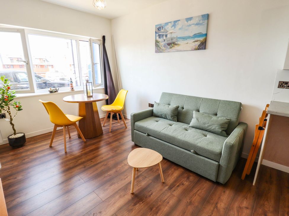 A living room with a sofa and dining table at The Ocean House--- Sea Shell in Hunstanton
