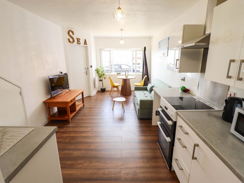 A kitchen with a sofa and a coffee table at The Ocean House--- Sea Shell Hunstanton