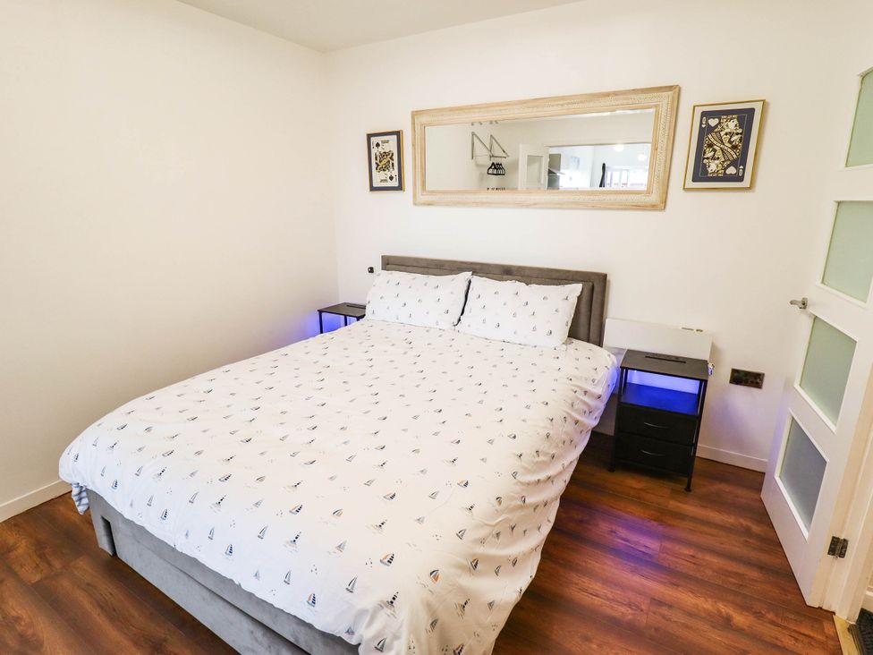 A bedroom with a bed and bedside table at The Ocean House--- Sea Shell in Hunstanton