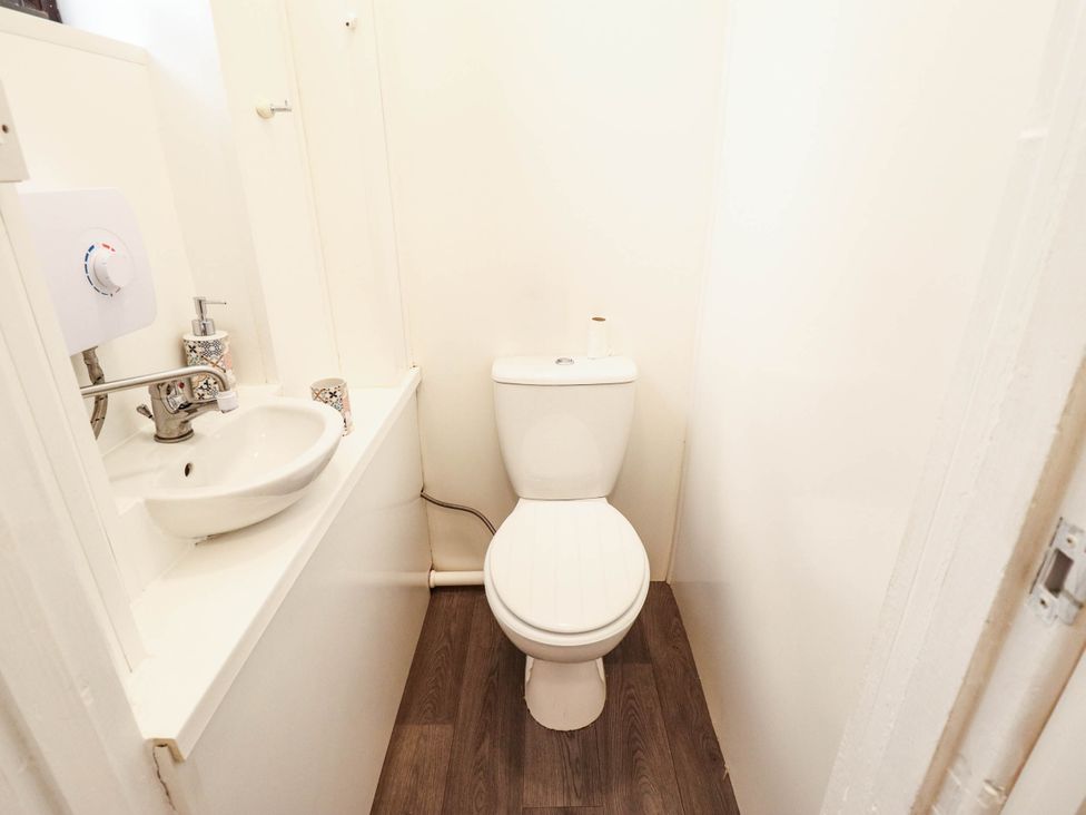 A bathroom with a toilet and sink at The Ocean House--- Sea Shell in Hunstanton
