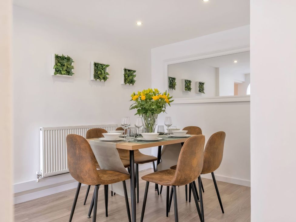 A dining room with a table and chairs at TBC