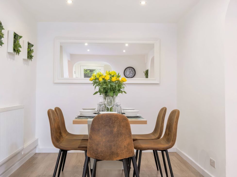 A dining room with a table and chairs at TBC 