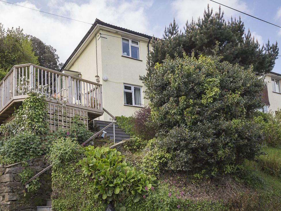 A house with a deck and stairs in front at 6 Knowle Court in Salcombe