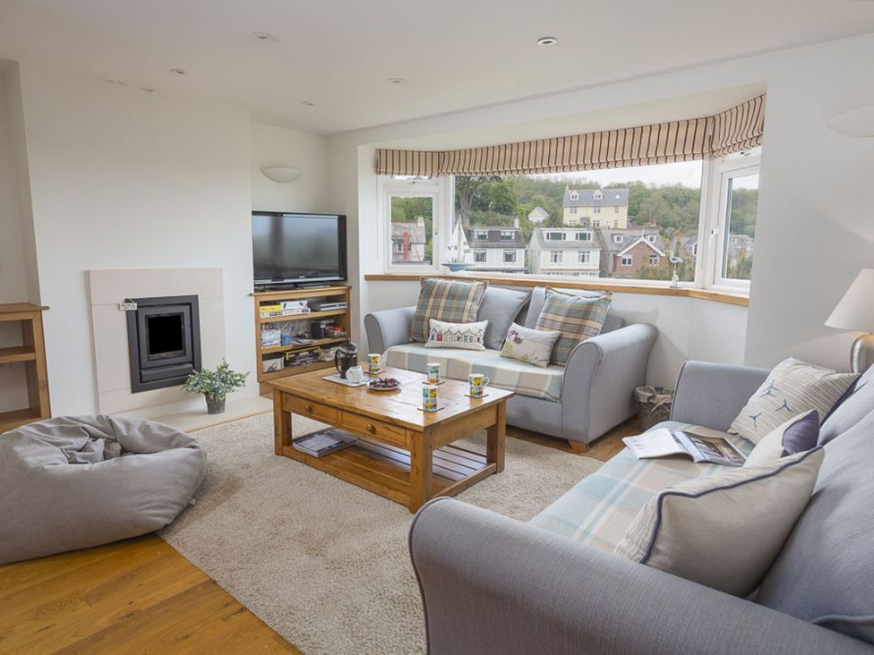 A living room with a coffee table and sofa at 6 Knowle Court in Salcombe