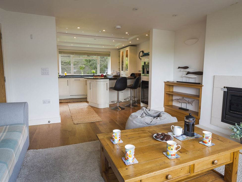 A living room with a couch and coffee table at 6 Knowle Court in Salcombe