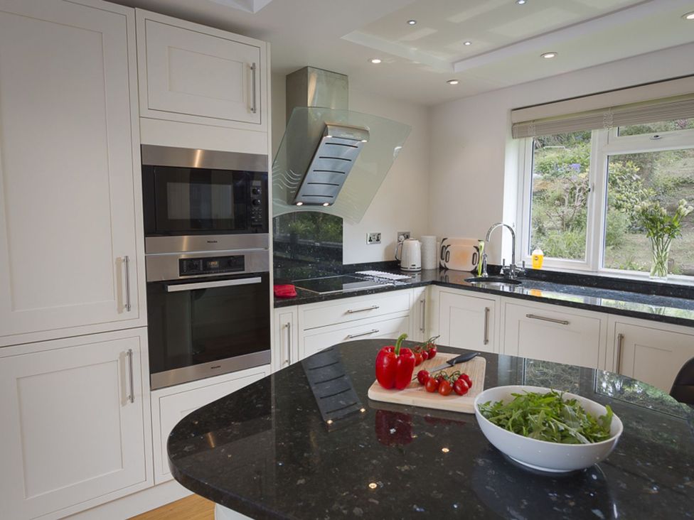 A kitchen with appliances and vegetables at 6 Knowle Court in Salcombe