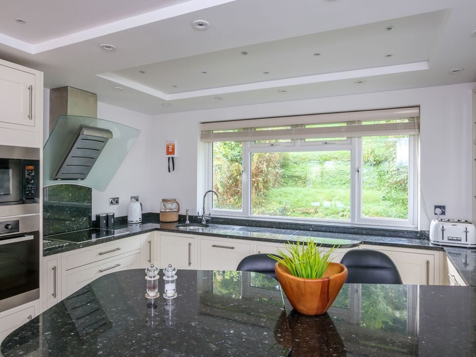 A kitchen with a counter and window at 6 Knowle Court in Salcombe