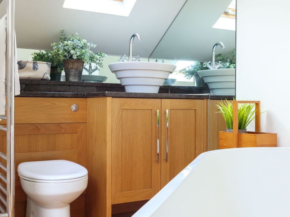 A bathroom with a sink and a toilet at 6 Knowle Court in Salcombe