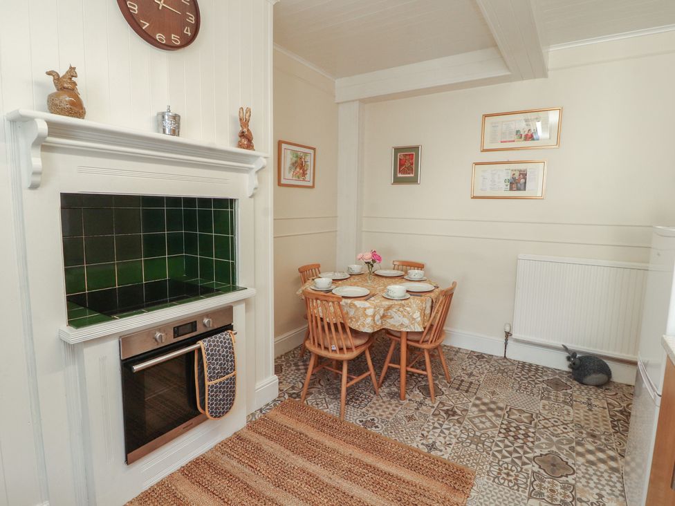 A kitchen with a dining table and oven at 30 George Street in Wigton