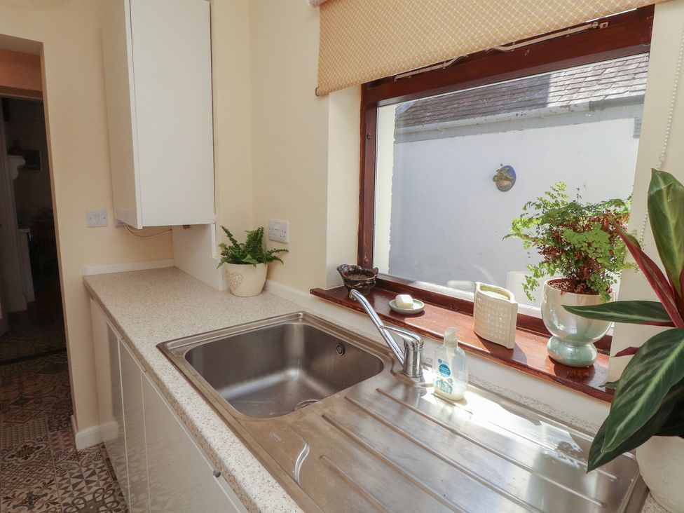 A kitchen with a sink and plants at 30 George Street in Wigton