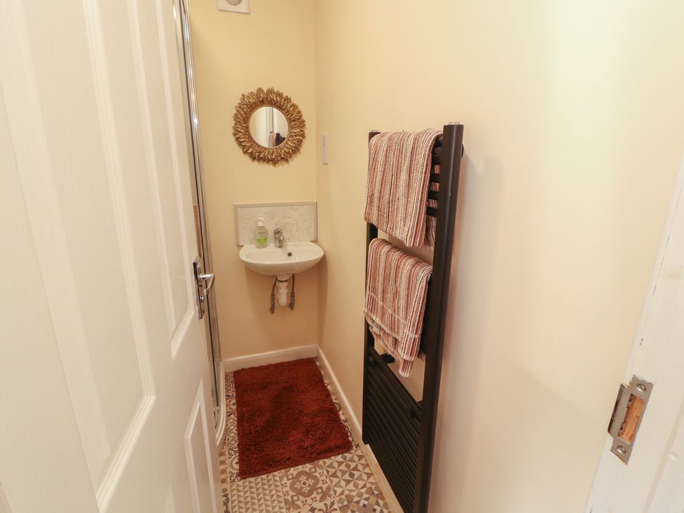 A bathroom with a hand basin and towel rack at 30 George Street in Wigton