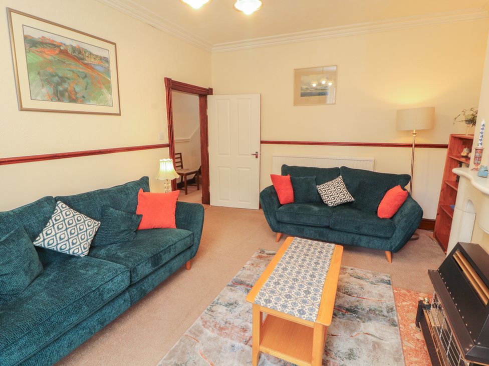 A living room with sofas and a table at 30 George Street in Wigton