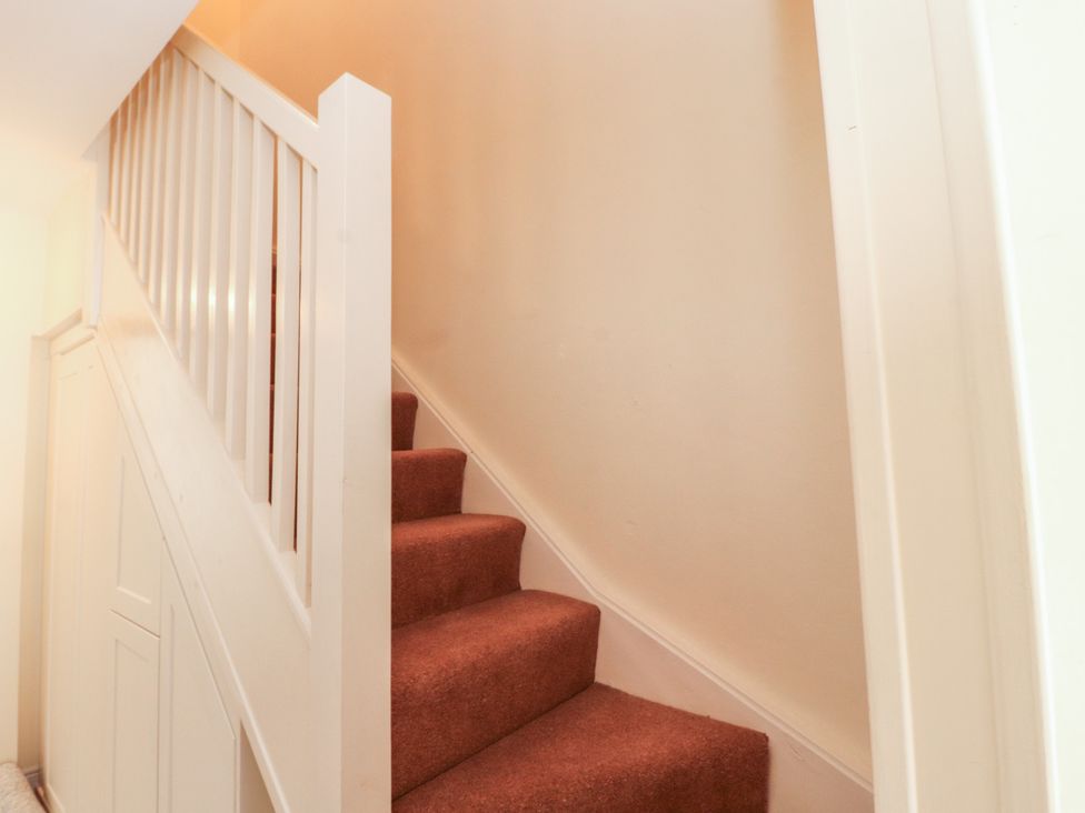 A staircase with carpet and railing at 30 George Street in Wigton