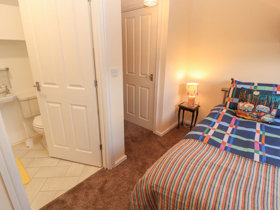A bedroom with a bed and a bathroom area at 30 George Street in Wigton
