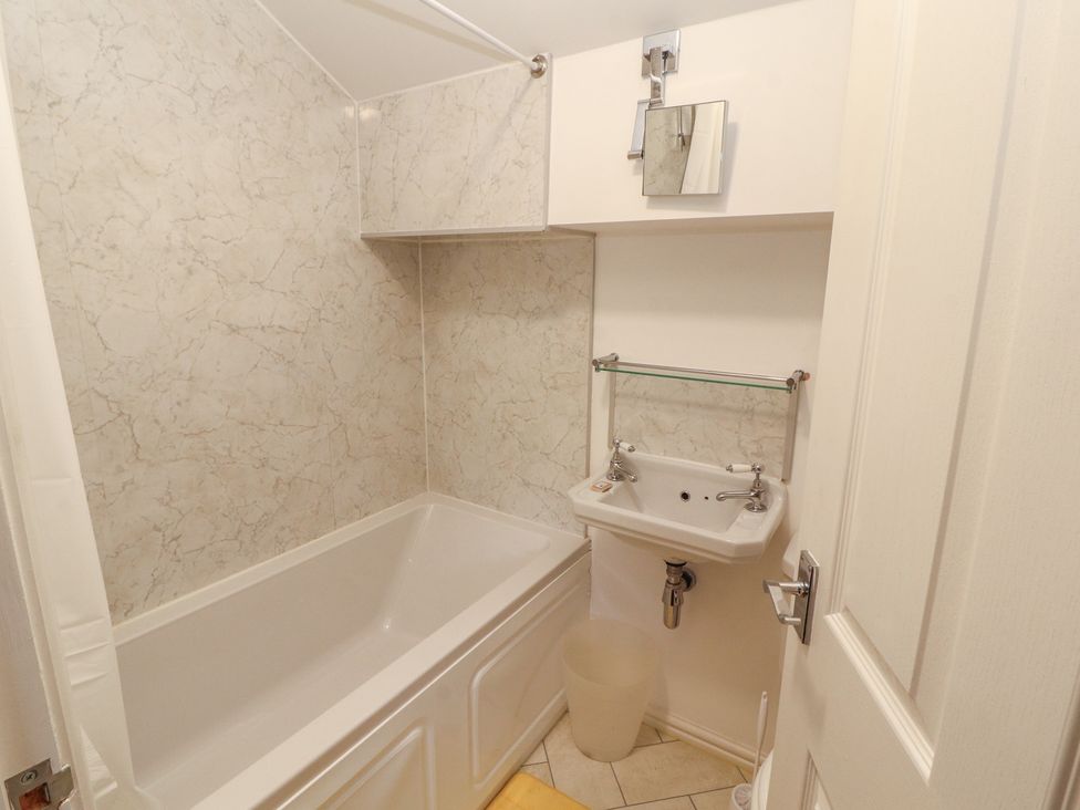 A bathroom with a bathtub and a sink at 30 George Street Wigton