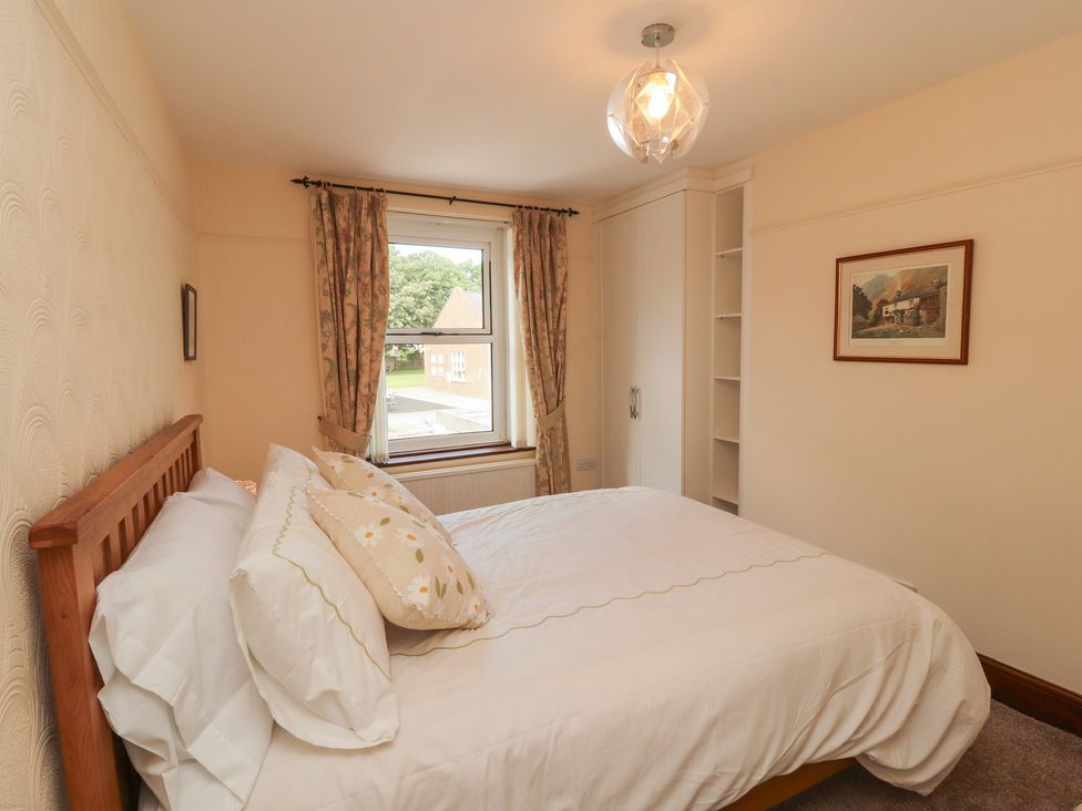 A bedroom with a bed and window at 30 George Street, Wigton
