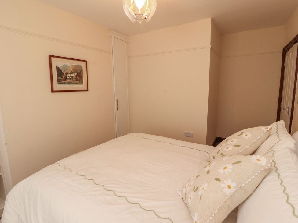 A bedroom with a bed and painting at 30 George Street Wigton
