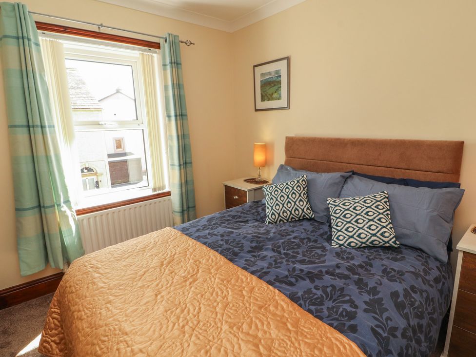 A bedroom with a bed and lamp at 30 George Street in Wigton