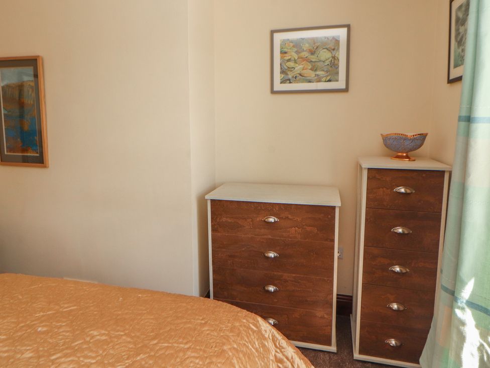 A chest of drawers with artwork on the wall at 30 George Street Wigton