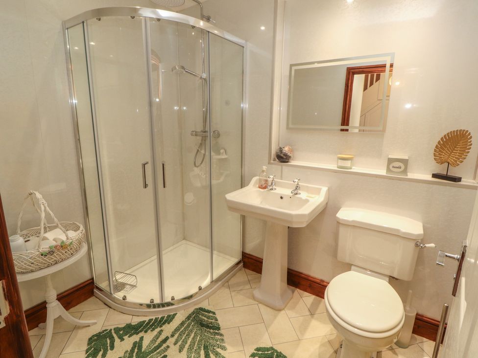 A bathroom with shower and sink at 30 George Street in Wigton