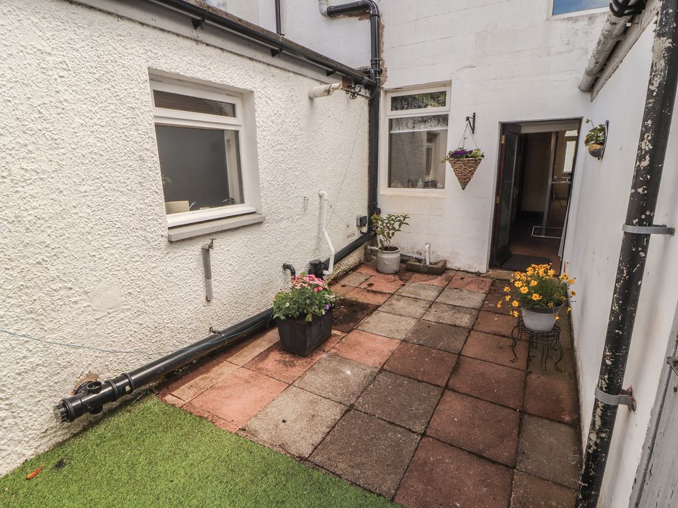 A garden area with flower pots and paved flooring at 30 George Street Wigton