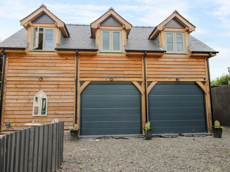 A garage with two doors and windows at Little Acre Leominster
