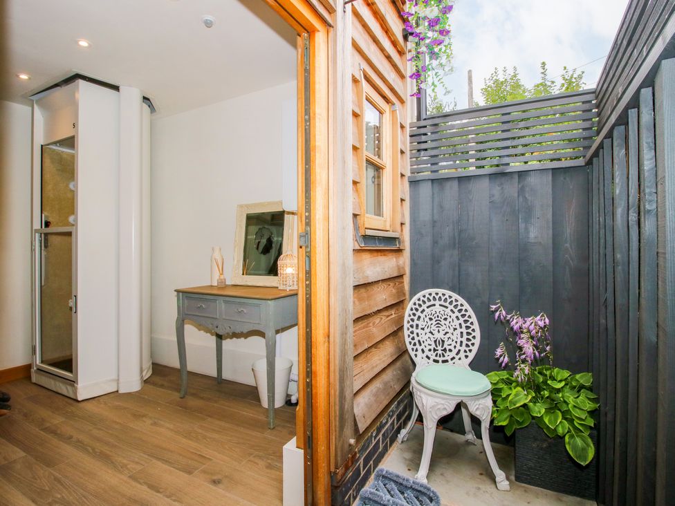 A bathroom with a shower and a table at Little Acre in Leominster