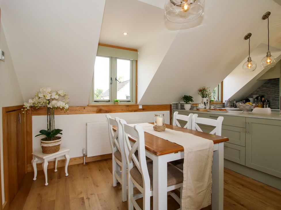 A kitchen with a dining table and chairs at Little Acre in Leominster
