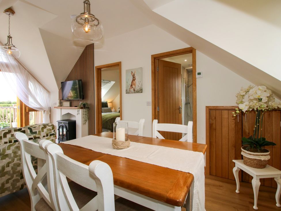 A dining area with a table and chairs at Little Acre in Leominster
